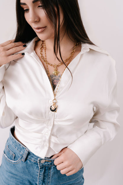 Fine detailed chain with hanging gold disc and 3 charms; round black enamel bee, square black charm and delicate 3D heart